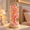 Cúpula de vidro com flores preservadas e LED rosa claro